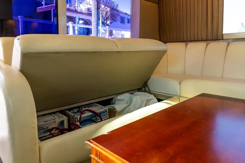 Falcon Yacht Photos Pics 1998 Ocean Yachts 48 Super Sport interior with storage under cream leather seating.