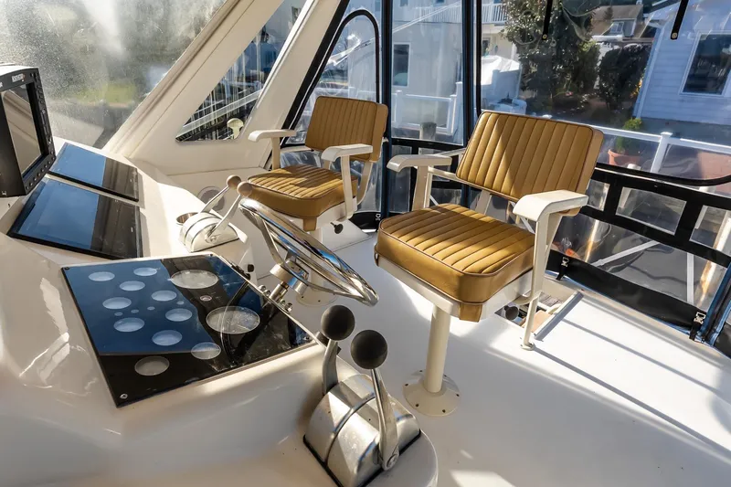 Falcon Yacht Photos Pics 1998 Ocean Yachts 48 Super Sport helm with dual captain chairs and navigation equipment.