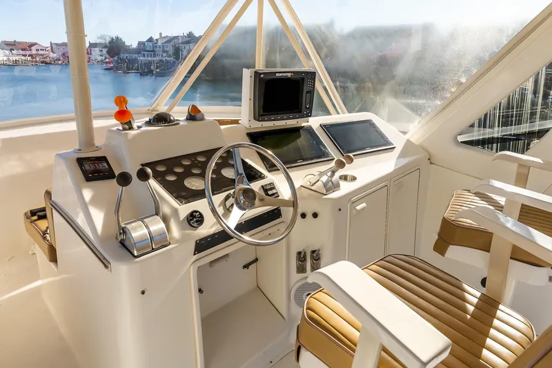 Falcon Yacht Photos Pics 1998 Ocean Yachts 48 Super Sport helm with navigation equipment and leather seats.