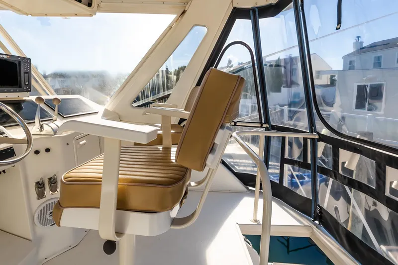 Falcon Yacht Photos Pics 1998 Ocean Yachts 48 Super Sport helm with tan seating and panoramic windows.