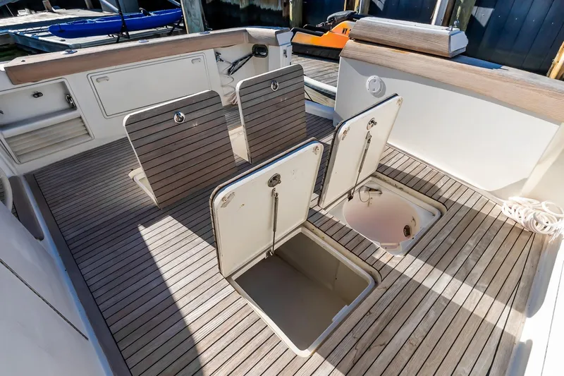 Falcon Yacht Photos Pics 1998 Ocean Yachts 48 Super Sport deck with open storage compartments and wooden flooring.