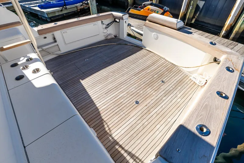 Falcon Yacht Photos Pics 1998 Ocean Yachts 48 Super Sport boat deck with wood finish, docked at marina.