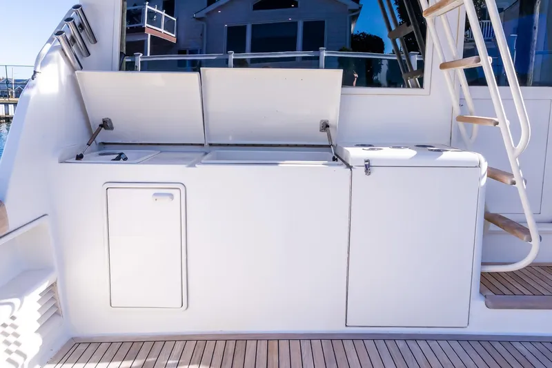 Falcon Yacht Photos Pics 1998 Ocean Yachts 48 Super Sport yacht deck with storage compartments and wooden steps.