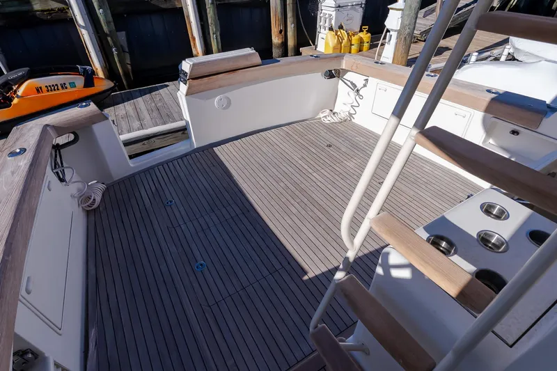 Falcon Yacht Photos Pics 1998 Ocean Yachts 48 Super Sport deck with wooden flooring and fishing rod holders.