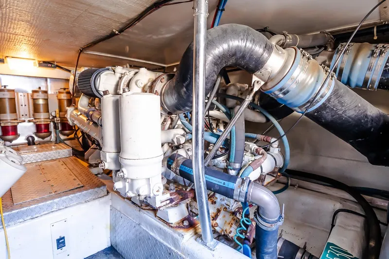 Falcon Yacht Photos Pics Engine room of 1998 Ocean Yachts 48 Super Sport, showcasing complex machinery and piping.