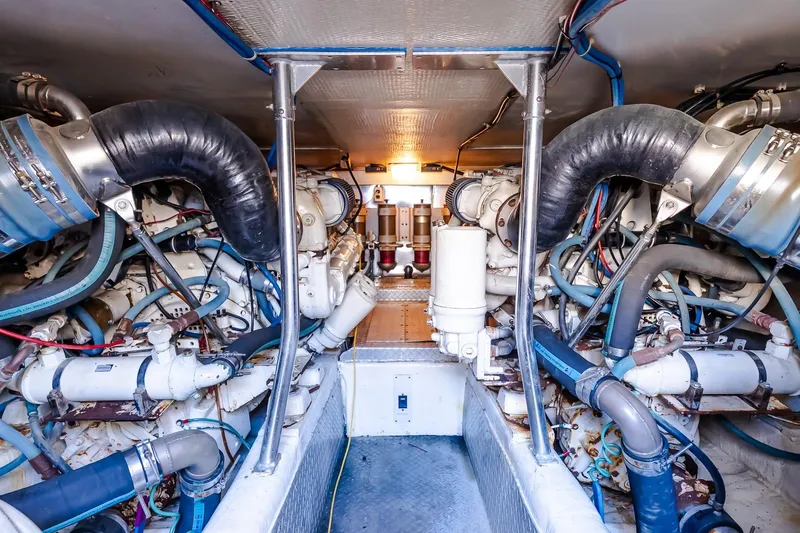 Falcon Yacht Photos Pics Engine room of 1998 Ocean Yachts 48 Super Sport, showcasing complex machinery and piping.