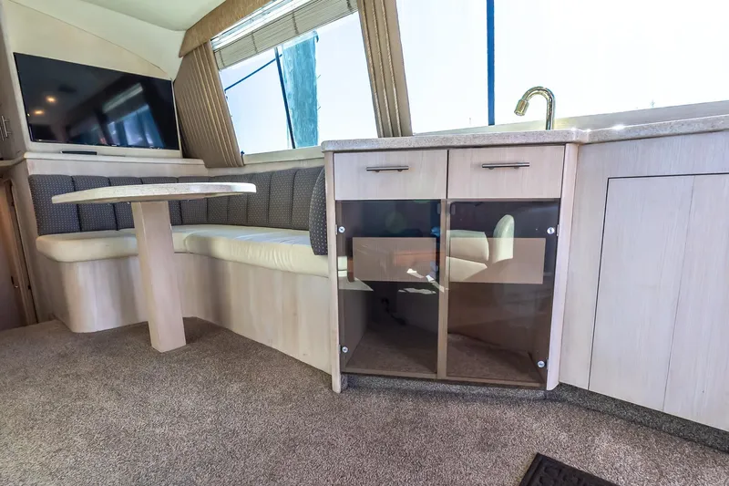 Falcon Yacht Photos Pics Interior of 1998 Ocean Yachts 48 Super Sport with seating, table, and cabinetry.