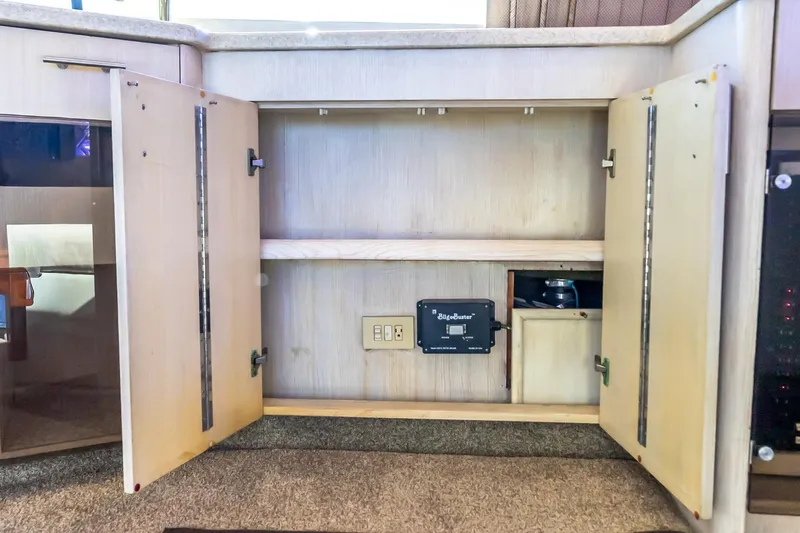 Falcon Yacht Photos Pics Open cabinet on 1998 Ocean Yachts 48 Super Sport, featuring BilgeBuster system.