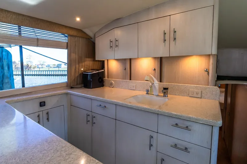 Falcon Yacht Photos Pics 1998 Ocean Yachts 48 Super Sport kitchen interior with modern cabinetry and sink.