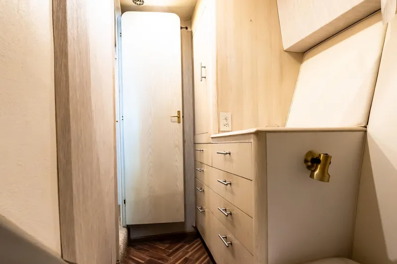 Falcon Yacht Photos Pics Narrow hallway with wooden cabinets inside a 1998 Ocean Yachts 48 Super Sport.