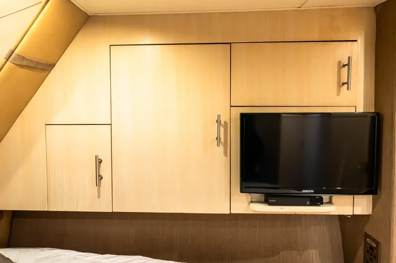 Falcon Yacht Photos Pics 1998 Ocean Yachts 48 Super Sport interior with TV and wooden cabinets.