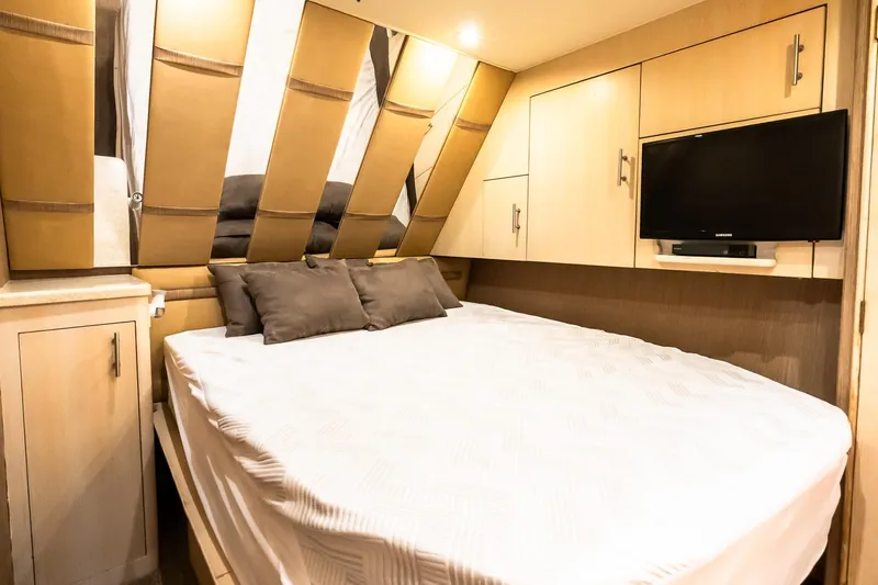 Falcon Yacht Photos Pics Luxurious bedroom interior of 1998 Ocean Yachts 48 Super Sport with modern amenities.