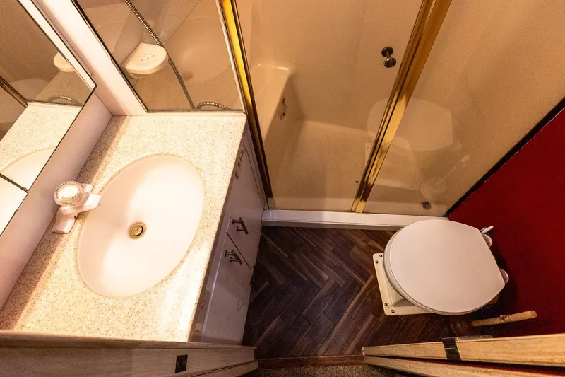 Falcon Yacht Photos Pics Bathroom interior of 1998 Ocean Yachts 48 Super Sport with sink, toilet, and shower.