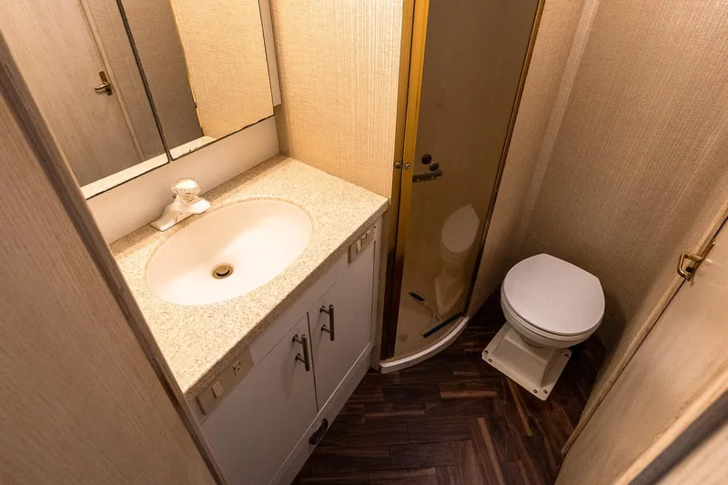 Falcon Yacht Photos Pics Bathroom interior of 1998 Ocean Yachts 48 Super Sport with shower, sink, and toilet.