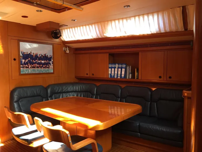  Yacht Photos Pics Luxurious interior of 1999 Nautor Swan 56 yacht with wooden table and leather seating.