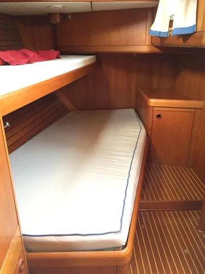  Yacht Photos Pics Nautor Swan 56 (1999) yacht cabin with wooden interior and bunk beds.