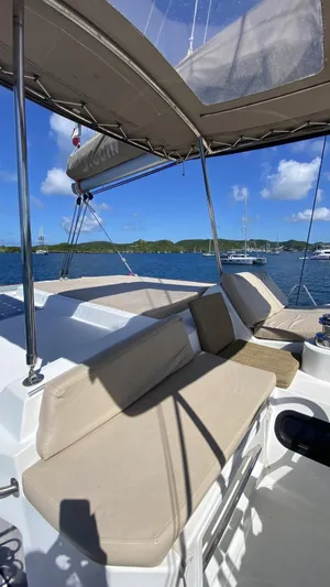  Yacht Photos Pics Luxurious Bali 4.0 catamaran deck with comfortable seating, 2017 model, anchored in serene waters.