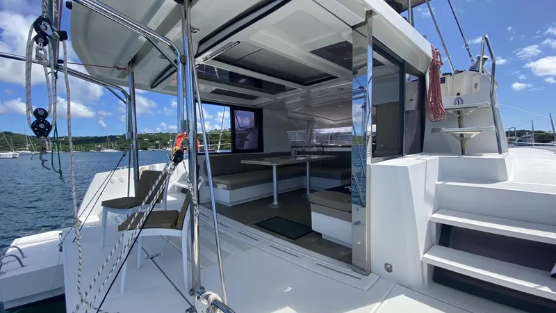  Yacht Photos Pics Bali 4.0 catamaran interior and deck, 2017 model, docked in a scenic marina.
