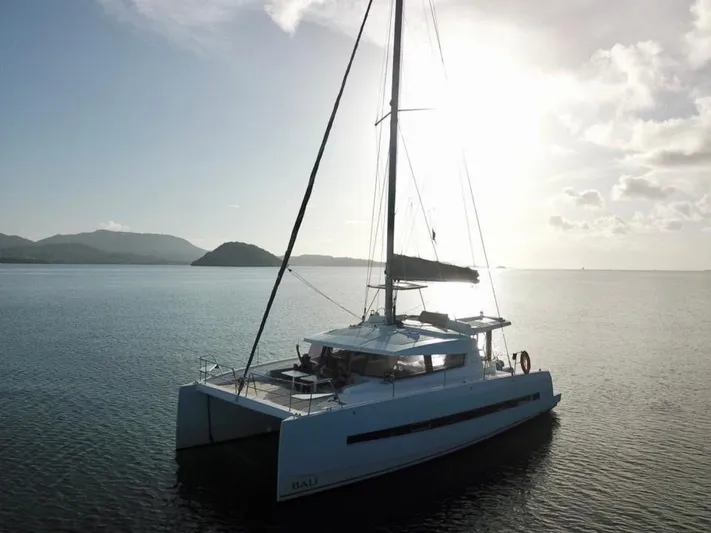  Yacht Photos Pics Sailing catamaran Bali 4.0, 2017 model, on calm waters at sunset.