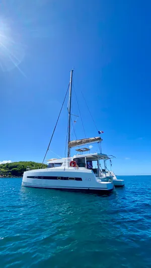  Yacht Photos Pics Sailing catamaran Bali 4.0, 2017 model, anchored in clear blue ocean under sunny sky.
