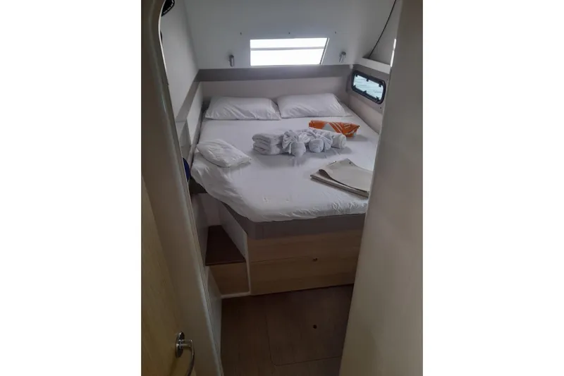  Yacht Photos Pics Cozy cabin bedroom in 2017 Bali 4.0 yacht with neatly arranged bed linens.
