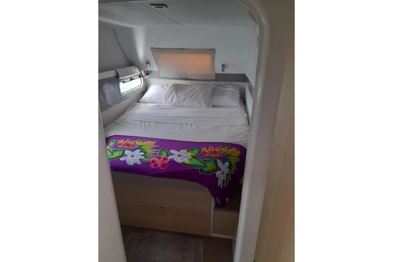  Yacht Photos Pics Cozy cabin bedroom in 2017 Bali 4.0 yacht with floral blanket and window view.