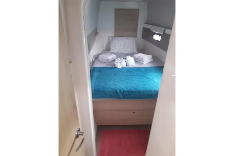  Yacht Photos Pics Cozy cabin interior of 2017 Bali 4.0 yacht with neatly arranged bed and towels.