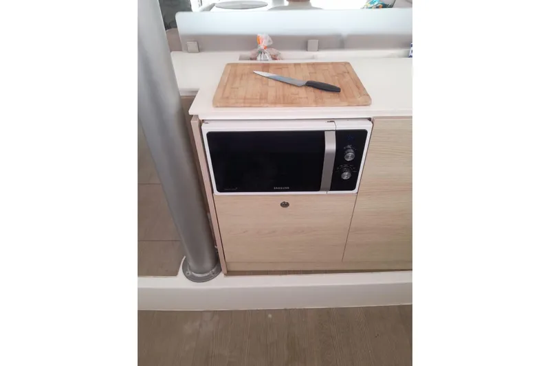  Yacht Photos Pics Modern kitchen area on a 2017 Bali 4.0 yacht with microwave and cutting board.