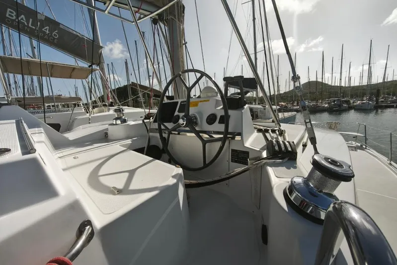  Yacht Photos Pics Cockpit view of a 2017 Bali 4.0 catamaran in a marina, featuring steering wheel and winches.
