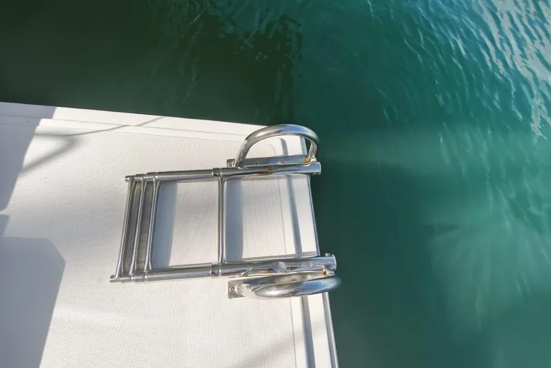  Yacht Photos Pics Stainless steel boat ladder on a Bali 4.0 catamaran, 2017 model, near turquoise water.
