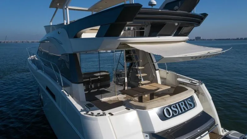 Osiris Yacht Photos Pics Luxury 2022 Beneteau Monte Carlo 6 yacht on open water, featuring spacious deck and seating.