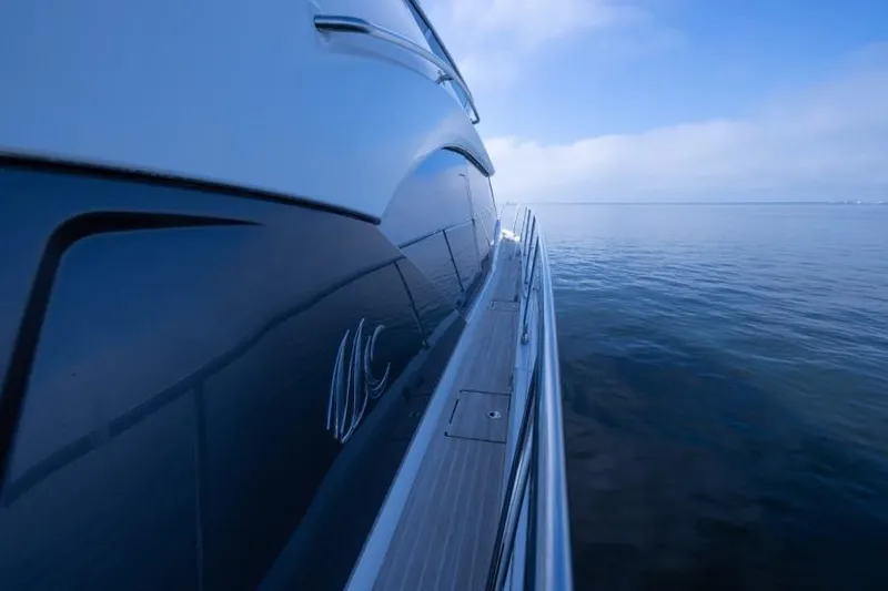 Osiris Yacht Photos Pics Side view of 2022 Beneteau Monte Carlo 6 yacht on calm sea.