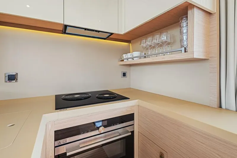 Osiris Yacht Photos Pics Modern kitchen in 2022 Beneteau Monte Carlo 6 yacht with stove and glassware.