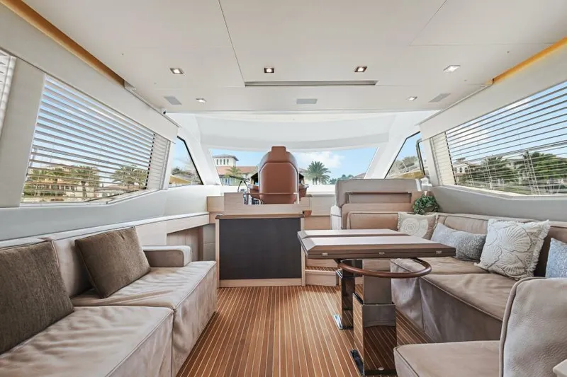 Osiris Yacht Photos Pics Luxurious interior of 2022 Beneteau Monte Carlo 6 yacht with elegant seating and panoramic windows.