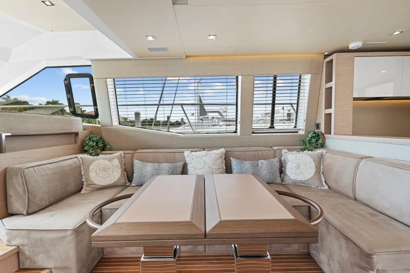 Osiris Yacht Photos Pics Luxurious interior of 2022 Beneteau Monte Carlo 6 yacht with plush seating and elegant decor.