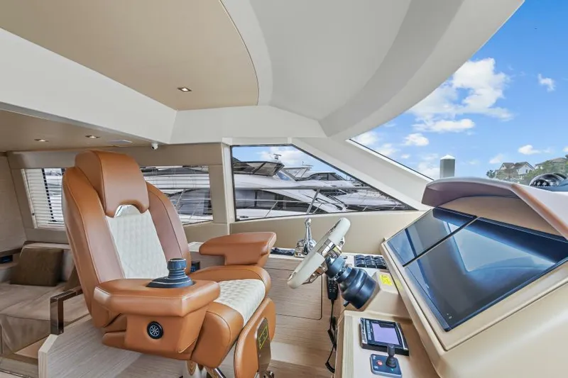 Osiris Yacht Photos Pics Luxurious interior of 2022 Beneteau Monte Carlo 6 yacht with leather captain's chair and modern controls.