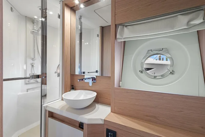Osiris Yacht Photos Pics Luxurious bathroom interior of 2022 Beneteau Monte Carlo 6 yacht with modern fixtures.