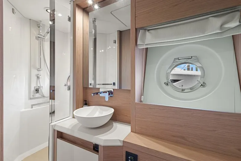 Osiris Yacht Photos Pics Luxurious bathroom in 2022 Beneteau Monte Carlo 6 yacht with modern fixtures.