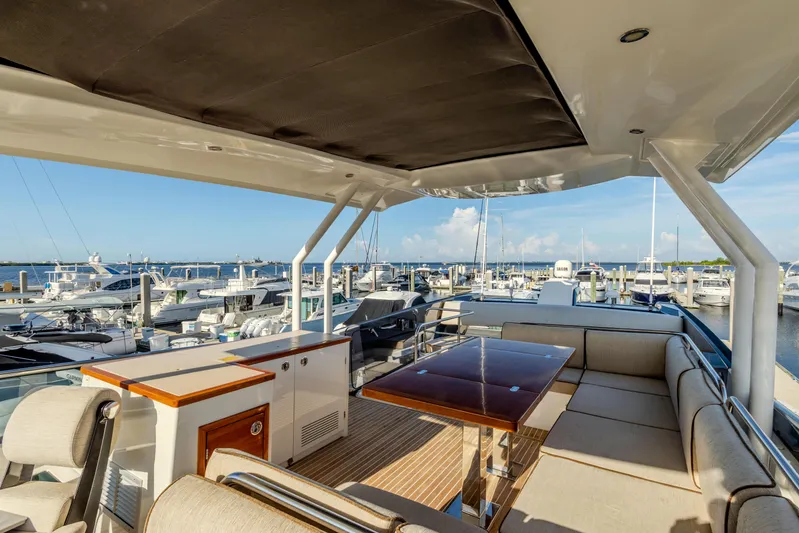 Osiris Yacht Photos Pics Luxurious 2022 Beneteau Monte Carlo 6 yacht interior with elegant seating and marina view.