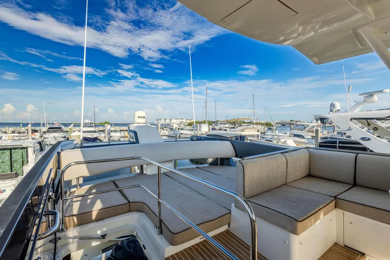 Osiris Yacht Photos Pics Luxurious 2022 Beneteau Monte Carlo 6 yacht with spacious deck and marina view.