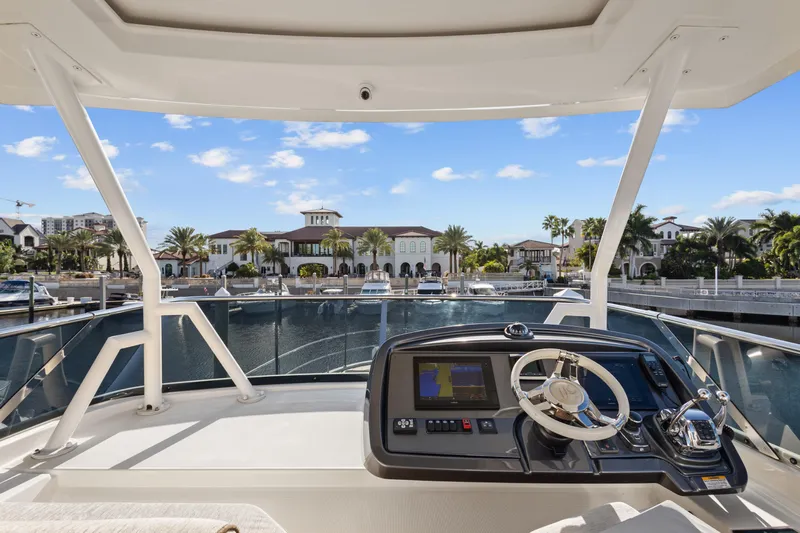 Osiris Yacht Photos Pics 2022 Beneteau Monte Carlo 6 yacht helm with waterfront view.