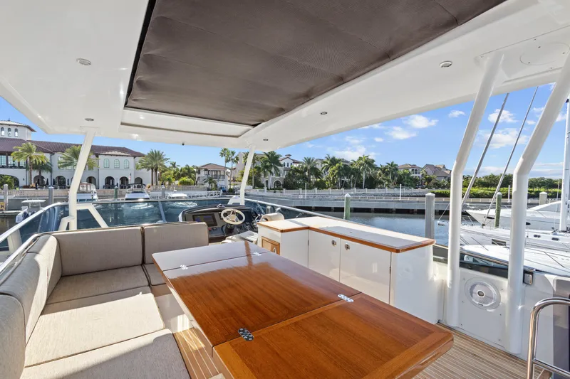 Osiris Yacht Photos Pics Luxurious 2022 Beneteau Monte Carlo 6 yacht interior with elegant seating and marina view.