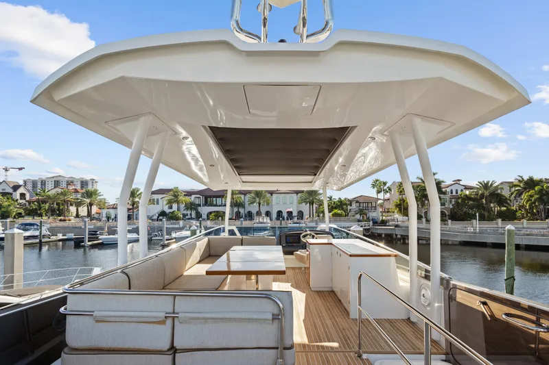 Osiris Yacht Photos Pics Luxurious 2022 Beneteau Monte Carlo 6 yacht interior with spacious seating and waterfront view.