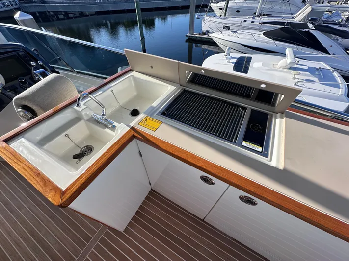 Osiris Yacht Photos Pics Outdoor kitchen on 2022 Beneteau Monte Carlo 6 yacht with sink and grill.
