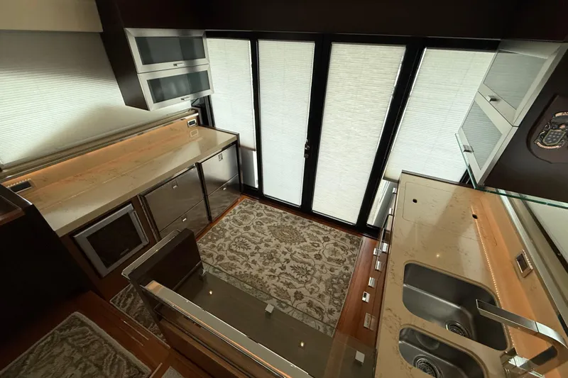  Yacht Photos Pics Luxurious kitchen interior of 2016 Tiara Yachts 50 Coupe with modern appliances and elegant design.