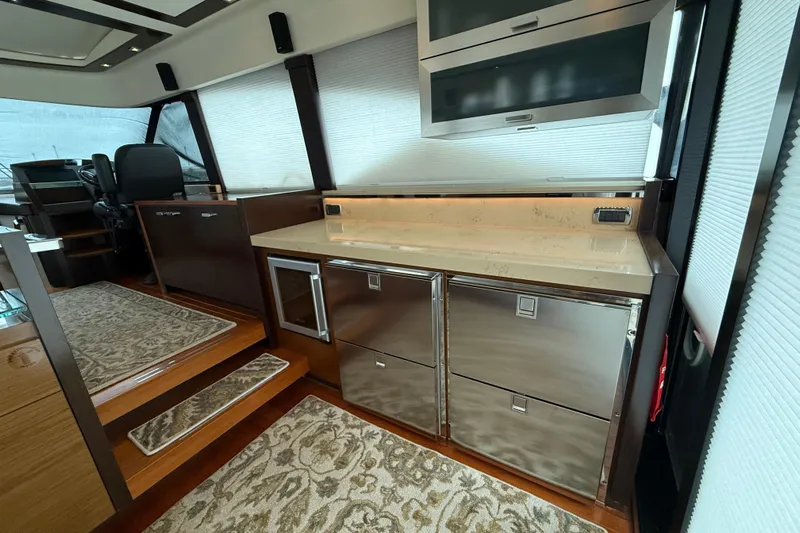  Yacht Photos Pics Luxurious interior of 2016 Tiara Yachts 50 Coupe with modern kitchen amenities.