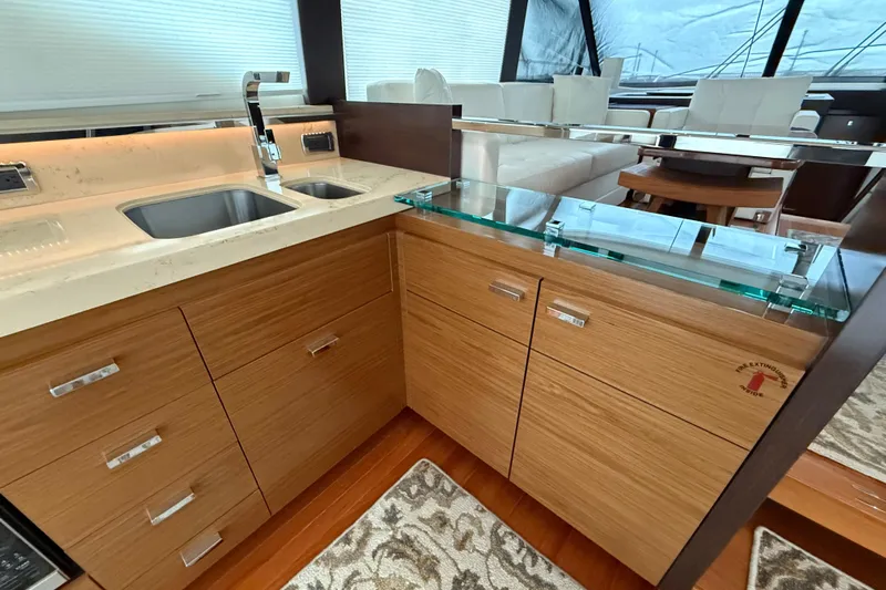  Yacht Photos Pics Luxurious 2016 Tiara Yachts 50 Coupe interior with modern kitchen and elegant wood cabinetry.