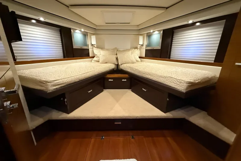  Yacht Photos Pics Luxurious 2016 Tiara Yachts 50 Coupe bedroom with twin beds and elegant lighting.