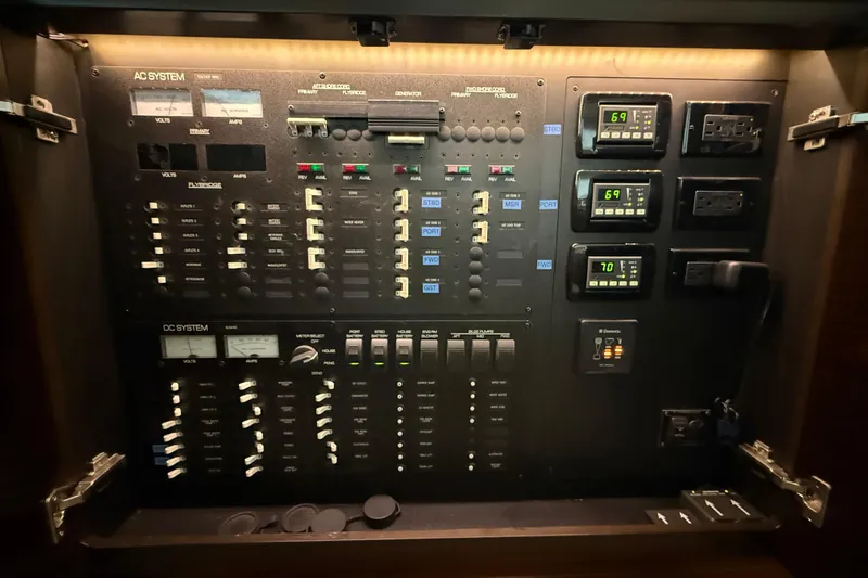  Yacht Photos Pics Electrical control panel of a 2016 Tiara Yachts 50 Coupe, featuring AC and DC systems.