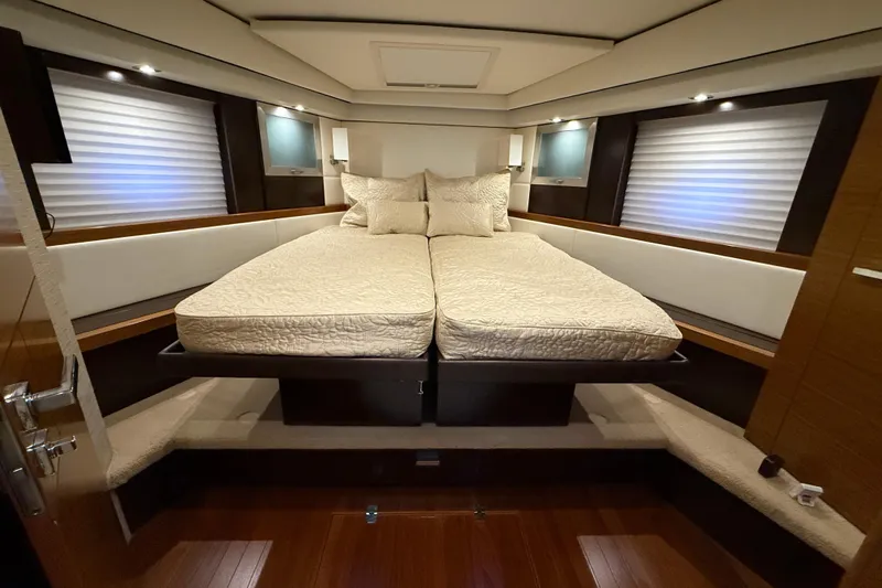  Yacht Photos Pics Luxurious bedroom interior of 2016 Tiara Yachts 50 Coupe with elegant bedding and ambient lighting.
